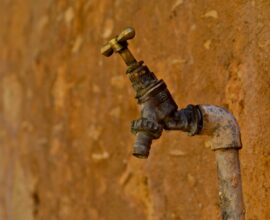 selective focus photography of brown faucet