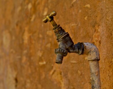 selective focus photography of brown faucet