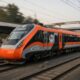 An orange and grey train speeds down the tracks
