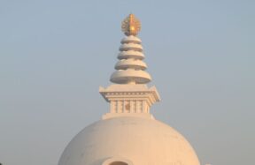 The Vishwa Shanti Stupa captures the serene beauty of sunrise with its iconic architecture.