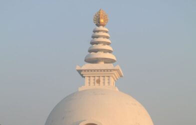 The Vishwa Shanti Stupa captures the serene beauty of sunrise with its iconic architecture.