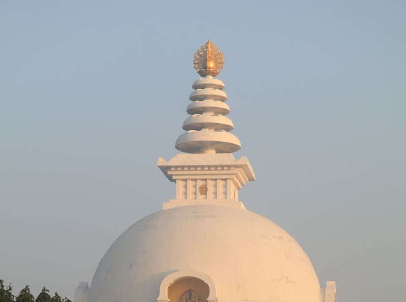 The Vishwa Shanti Stupa captures the serene beauty of sunrise with its iconic architecture.