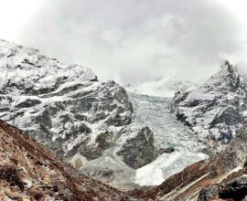 A mountain range covered in snow and clouds