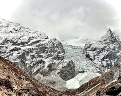 A mountain range covered in snow and clouds