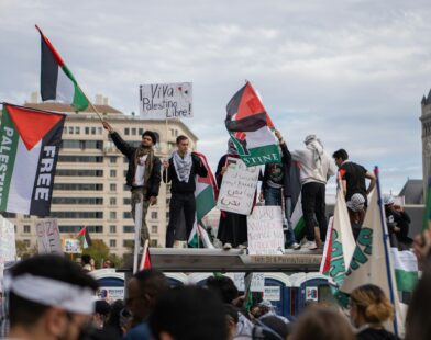 a group of people standing on top of a wooden platform