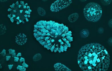 a group of blue and green cells on a black surface