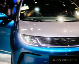 a close up of the front of a blue and white car
