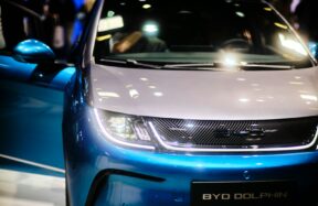 a close up of the front of a blue and white car
