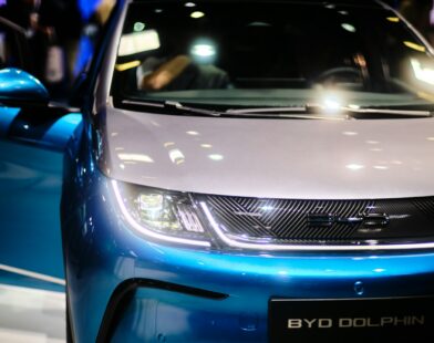 a close up of the front of a blue and white car