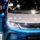 a close up of the front of a blue and white car