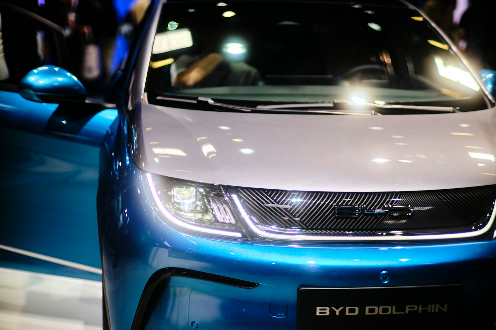 a close up of the front of a blue and white car