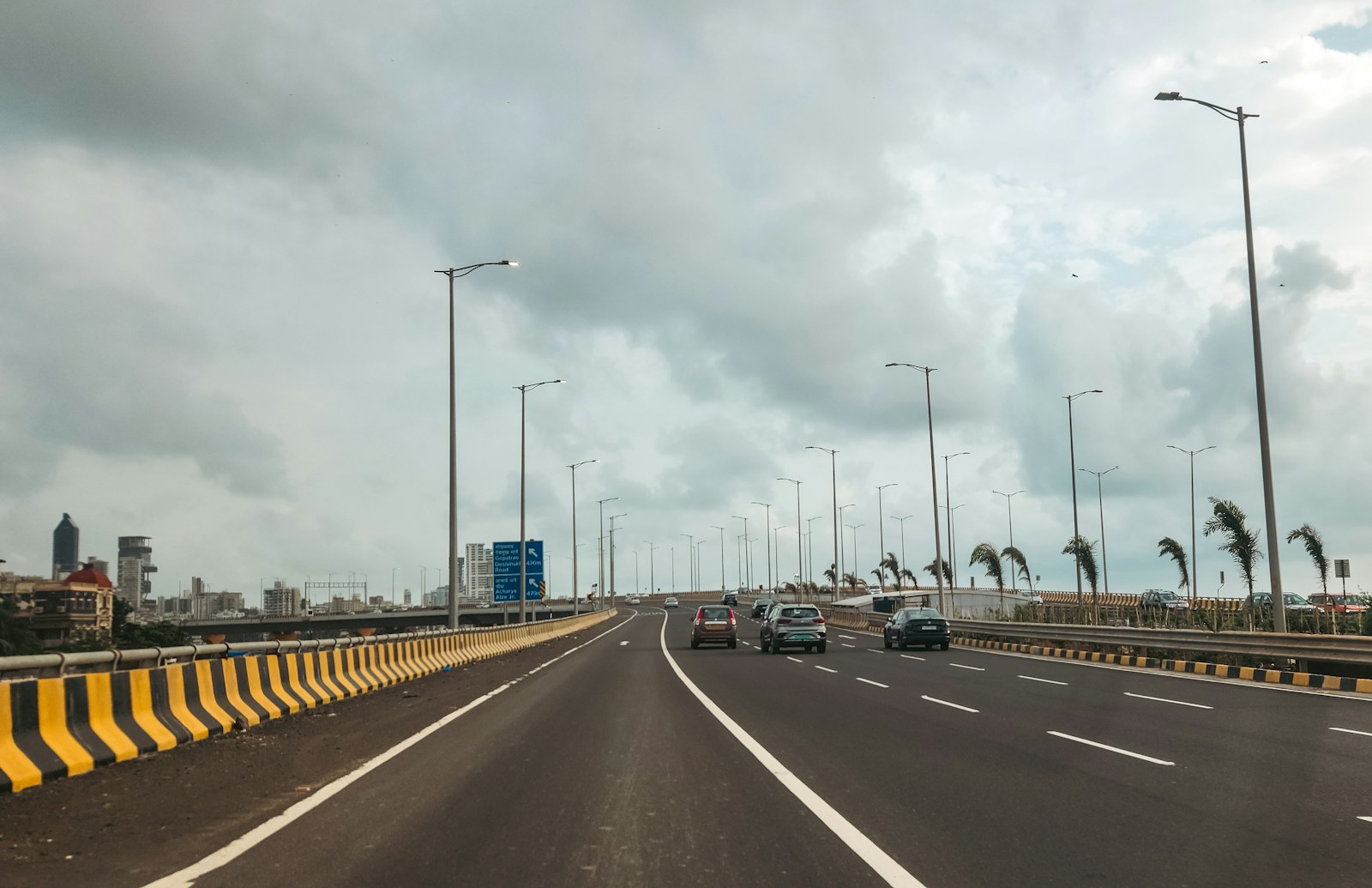 Cars are driving on a long, empty highway