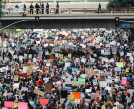 a large group of people holding up signs