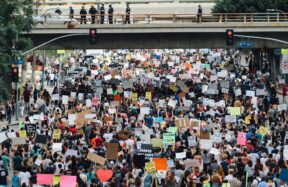 a large group of people holding up signs