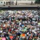 a large group of people holding up signs