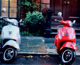 white and red motor scooters parked side-by-side