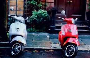white and red motor scooters parked side-by-side