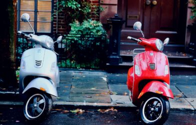white and red motor scooters parked side-by-side