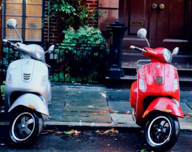 white and red motor scooters parked side-by-side