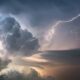 A dramatic lightning strike illuminates stormy clouds