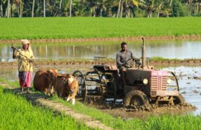 man riding farm equipment during daytime