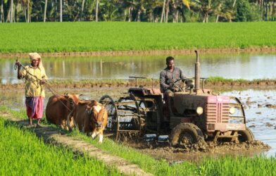 man riding farm equipment during daytime