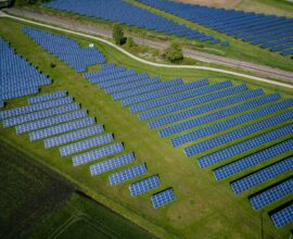 aerial photography of grass field with blue solar panels