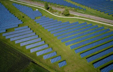 aerial photography of grass field with blue solar panels
