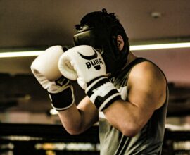 a man wearing a white and black boxing glove