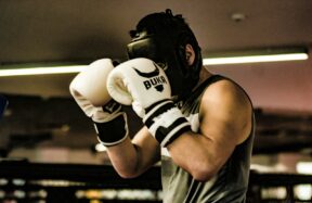 a man wearing a white and black boxing glove