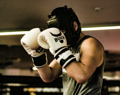 a man wearing a white and black boxing glove