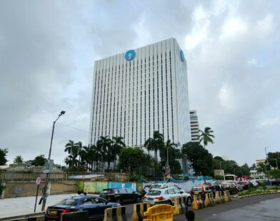 A tall bank building stands under a cloudy sky