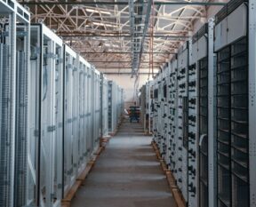 server room aisle with metal equipment racks
