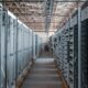 server room aisle with metal equipment racks