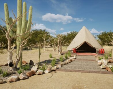 Desert glamping tent with cactus under a blue sky
