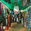Colorful clothing and flip-flops displayed at a market stall