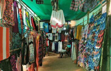 Colorful clothing and flip-flops displayed at a market stall