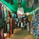 Colorful clothing and flip-flops displayed at a market stall