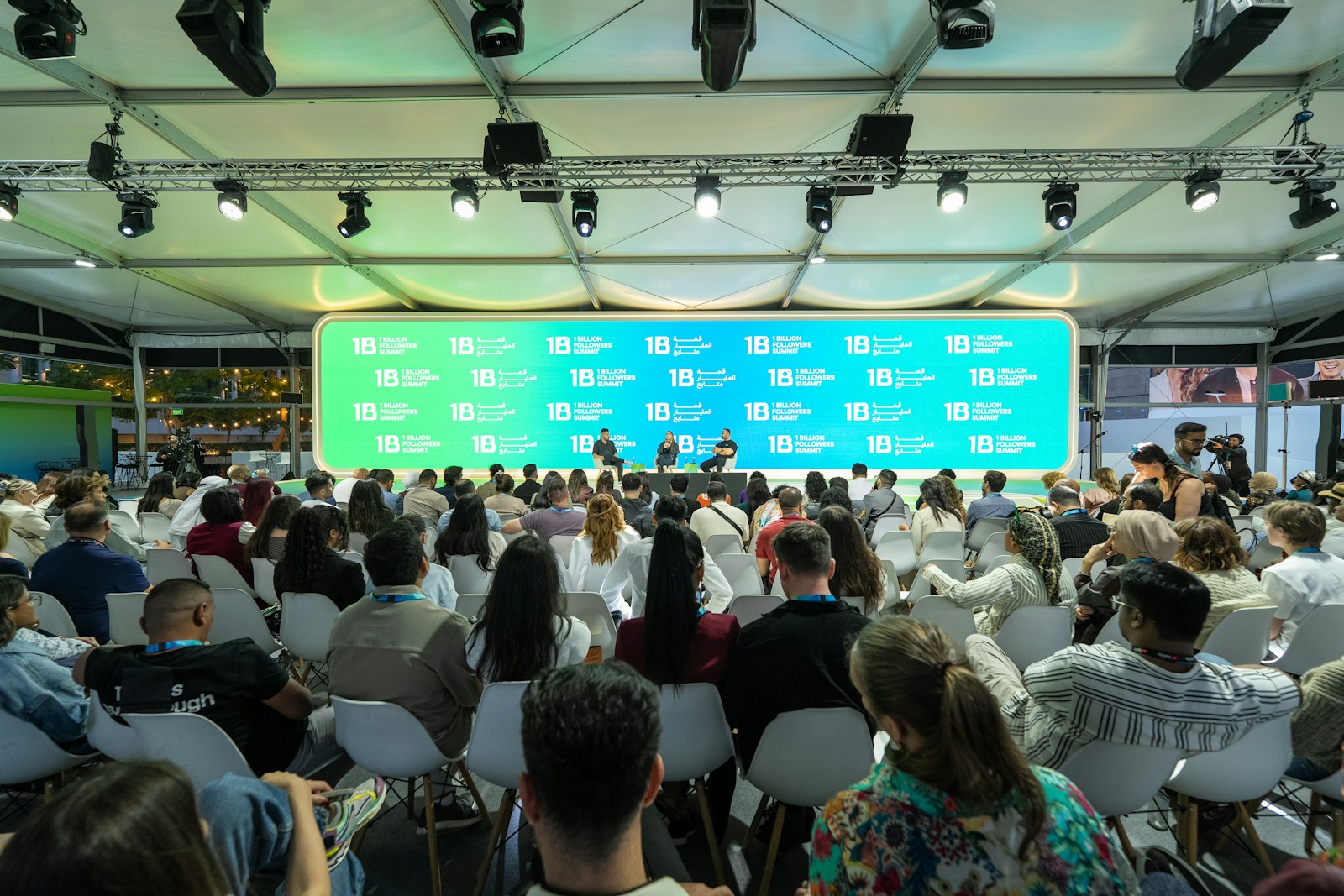 Audience watches a presentation on a large screen