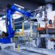 blue industrial robot arm in factory
