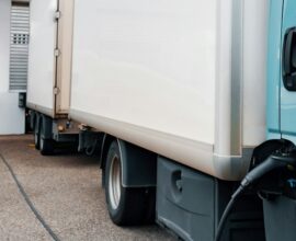 A blue truck parked in front of a building