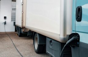 A blue truck parked in front of a building