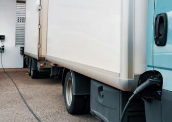 A blue truck parked in front of a building
