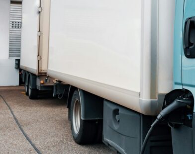 A blue truck parked in front of a building