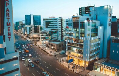 Busy city street with cars and tall buildings at dusk