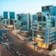 Busy city street with cars and tall buildings at dusk