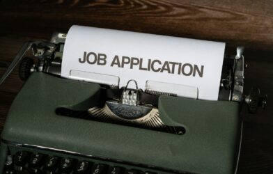 a typewriter with a job application printed on it