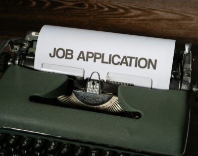 a typewriter with a job application printed on it